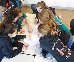 Schüler beraten sich an einem Tisch