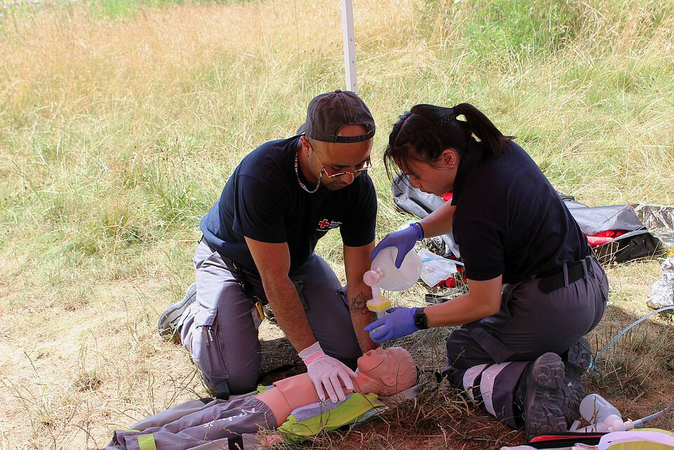 Eine Sanitäterin und ein Sanitäter beatmen bei der Übung ein Kleinkind